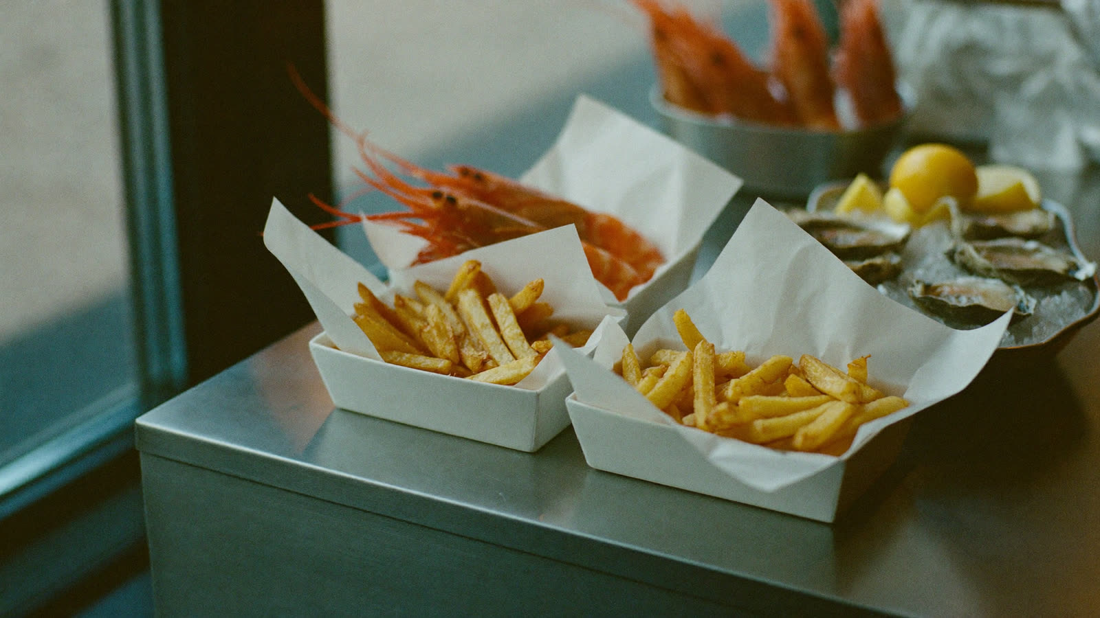 A premium spread of fresh seafood, prawns, oysters and beer-battered fish and chips at the Clayfield market counter